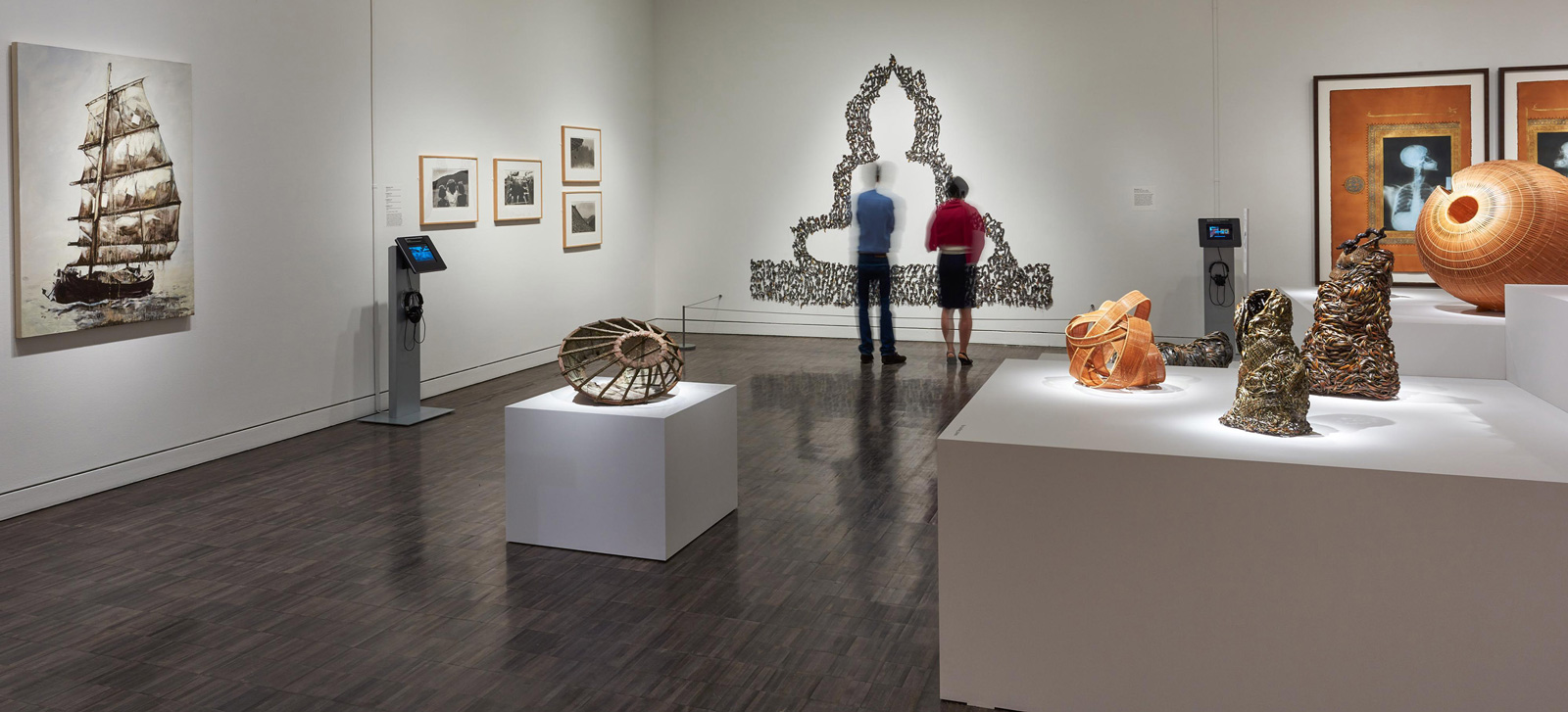 Two people standing in a gallery with contemporary works on display